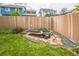 Serene backyard featuring a decorative pond, grassy area, and a tall wooden fence at 12133 Crabapple St, Broomfield, CO 80020