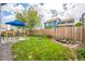 Lush backyard features a manicured lawn, pond, established landscaping, and privacy fence at 12133 Crabapple St, Broomfield, CO 80020