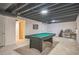 Finished basement featuring a pool table, exposed ceiling, and versatile layout at 12133 Crabapple St, Broomfield, CO 80020