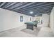 Finished basement featuring a billiards table, carpeted floors, and a painted, exposed ceiling at 12133 Crabapple St, Broomfield, CO 80020