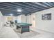 Finished basement featuring a pool table, game table and exposed ceiling at 12133 Crabapple St, Broomfield, CO 80020