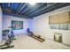 Finished basement with exercise equipment including bike, rowing machine, and exposed ceiling at 12133 Crabapple St, Broomfield, CO 80020