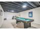 Finished basement with a pool table, exposed ceiling, and flexible layout at 12133 Crabapple St, Broomfield, CO 80020