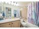 Cozy bathroom featuring a tub-shower combo, vanity, toilet, and decorative elements at 12133 Crabapple St, Broomfield, CO 80020