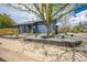 Charming blue home with lovely stone landscaping, green grass, and mature tree at 12133 Crabapple St, Broomfield, CO 80020