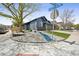 Charming home with rock landscaping, a mature tree, and a view of neighborhood street signs at 12133 Crabapple St, Broomfield, CO 80020