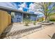 Landscaped front yard with a retaining wall and a charming front porch at 12133 Crabapple St, Broomfield, CO 80020