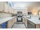 Well-equipped kitchen with stainless appliances, light cabinets, and open layout at 12133 Crabapple St, Broomfield, CO 80020