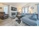 Cozy living room with fireplace, gray sofa, leather chair, and ample natural light at 12133 Crabapple St, Broomfield, CO 80020