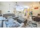 Spacious living room with grey sofa, vaulted ceiling, and open floor plan at 12133 Crabapple St, Broomfield, CO 80020