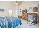 Well-lit bedroom featuring a large bed, desk, and access to the ensuite bathroom at 12133 Crabapple St, Broomfield, CO 80020