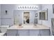 Bright bathroom featuring a double sink vanity, large mirror, and modern fixtures at 3857 Mossy Rock Dr # 201, Highlands Ranch, CO 80126