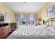 Bedroom with light yellow walls and a large window providing ample natural light at 3857 Mossy Rock Dr # 201, Highlands Ranch, CO 80126