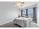 Bedroom featuring a ceiling fan, a window, and soft gray carpet at 3857 Mossy Rock Dr # 201, Highlands Ranch, CO 80126