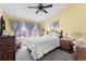 Relaxing bedroom with vaulted ceiling, a ceiling fan, and window overlooking the neighborhood at 3857 Mossy Rock Dr # 201, Highlands Ranch, CO 80126