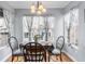 Inviting dining area features hardwood floors, modern lighting, and large windows with views at 3857 Mossy Rock Dr # 201, Highlands Ranch, CO 80126