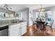 Efficient kitchen connects to dining area with granite counters and light cabinets at 3857 Mossy Rock Dr # 201, Highlands Ranch, CO 80126