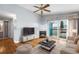 Comfortable living room with a fireplace, a ceiling fan, and sliding glass doors to a private deck at 3857 Mossy Rock Dr # 201, Highlands Ranch, CO 80126