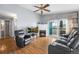 Spacious living room featuring neutral paint, fireplace, ceiling fan, and balcony access at 3857 Mossy Rock Dr # 201, Highlands Ranch, CO 80126