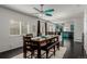 Open dining room with view into kitchen and large windows providing lots of natural light at 3788 Chavez St, Brighton, CO 80601