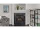 Cozy fireplace with dark tile surround, adding warmth and character to the living space at 3788 Chavez St, Brighton, CO 80601