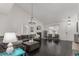 Bright living room with high ceilings, dark floors, and large windows letting in natural light at 3788 Chavez St, Brighton, CO 80601