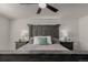 This main bedroom features a striking headboard, ceiling fan, and matching nightstands with lamps at 3788 Chavez St, Brighton, CO 80601