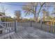 Wooden back deck overlooking a large yard with a wooden fence and some trees at 1205 W 101St Ave, Northglenn, CO 80260