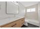 Modern bathroom features stylish vanity, quartz countertop, tile shower and contemporary fixtures at 1205 W 101St Ave, Northglenn, CO 80260
