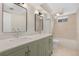 Bright bathroom featuring double sink vanity with modern fixtures and tiled shower and flooring at 1205 W 101St Ave, Northglenn, CO 80260