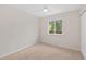 Bright bedroom with carpeted floors, ceiling fan, and a large window with green backyard views at 1205 W 101St Ave, Northglenn, CO 80260