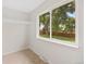 Bright bedroom with a large window overlooking a lush backyard, and a small shelf at 1205 W 101St Ave, Northglenn, CO 80260