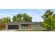 Charming ranch-style home with a well-maintained lawn, mature trees, and an attached garage at 1205 W 101St Ave, Northglenn, CO 80260