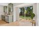 Bright kitchen with stainless steel dishwasher, green cabinets, and access to a large backyard through sliding glass doors at 1205 W 101St Ave, Northglenn, CO 80260