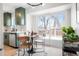 Eat-in kitchen features modern appliances, a dining table, and sliding glass doors to the deck at 1205 W 101St Ave, Northglenn, CO 80260