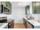 Well-lit kitchen features stainless steel appliances, sleek countertops, and modern fixtures at 1205 W 101St Ave, Northglenn, CO 80260