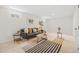 Bright basement living room featuring two windows and stylish modern decor, including rugs and plants at 1205 W 101St Ave, Northglenn, CO 80260