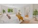 Bright main bedroom with a ceiling fan, a large window and a door to the ensuite bathroom at 1205 W 101St Ave, Northglenn, CO 80260