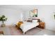 Bright main bedroom with decorative rug, a large art piece and a door to the ensuite bathroom at 1205 W 101St Ave, Northglenn, CO 80260