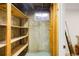 Unfinished storage area with rustic wood shelving and small window providing natural light at 1205 W 101St Ave, Northglenn, CO 80260