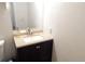 Half bath featuring vanity with cabinet, stone countertop, and tile floors at 1255 S Wheeling Way, Aurora, CO 80012