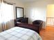 Bedroom includes dresser, chair, hardwood floors, and natural light at 1255 S Wheeling Way, Aurora, CO 80012