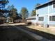 Exterior view of the townhouse with mature trees and landscaping in a well-maintained community at 1255 S Wheeling Way, Aurora, CO 80012