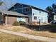 Two-story blue townhouse featuring a well-maintained lawn and a welcoming entrance at 1255 S Wheeling Way, Aurora, CO 80012