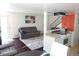 Cozy living room open to the kitchen, enhancing the home's welcoming atmosphere at 1255 S Wheeling Way, Aurora, CO 80012