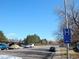 Street view with ample parking, a blue sky and mature trees at 1255 S Wheeling Way, Aurora, CO 80012