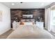 Bedroom featuring wood accent wall, neutral decor, bedside tables with lamps, and soft carpet at 8049 Monte Vista Cir, Littleton, CO 80125