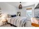 Serene bedroom with a patterned bedspread, a woven pendant light, and a large window at 8049 Monte Vista Cir, Littleton, CO 80125