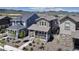 Attractive two-story home with a welcoming front porch, complemented by tasteful landscaping and a serene mountain view at 8049 Monte Vista Cir, Littleton, CO 80125