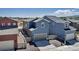 Contemporary blue two-story home with a gray garage door, complemented by modern landscaping and a welcoming curb appeal at 8049 Monte Vista Cir, Littleton, CO 80125
